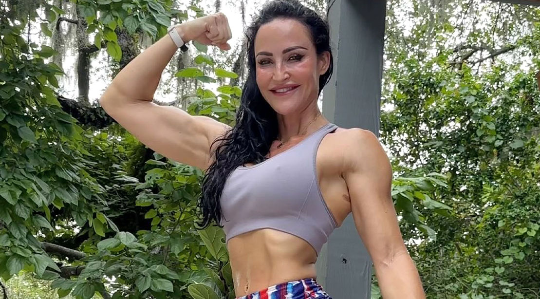 Female trainer and bodybuilder Erin Strern flexing her biceps after sharing her HIIT tips on social media