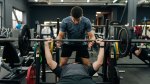 Fitness Trainer sharing his bench press tips with his clients